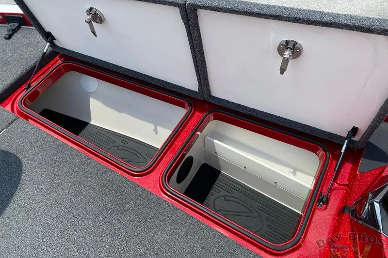Slide: The Image of 2020 Ranger Z520L boat storage compartments with secure locks and carpeted interior. - 77