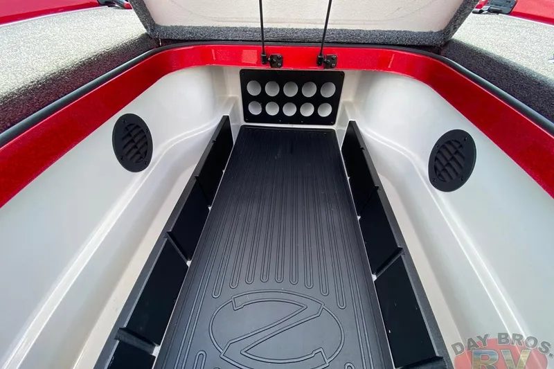 Slide: The Image of 2020 Ranger Z520L boat storage compartment with red trim and black mat. - 79