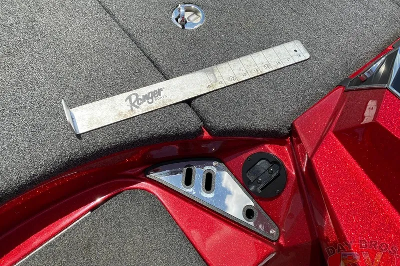 Slide: The Image of 2020 Ranger Z520L boat deck with measuring tool and red metallic finish. - 85