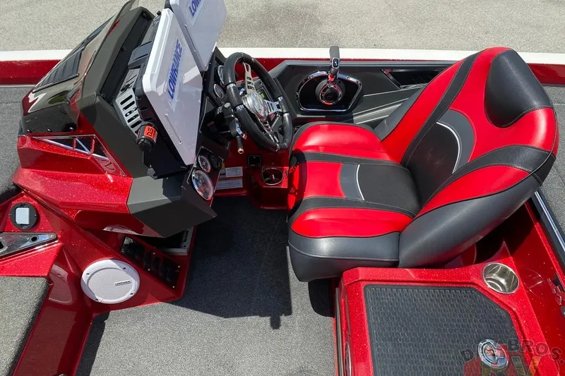 Slide: The Image of 2020 Ranger Z520L boat cockpit with red and black seat, steering wheel, and control panel. - 93