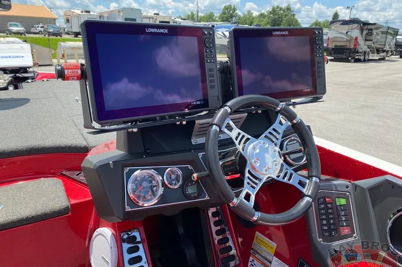 Slide: The Image of 2020 Ranger Z520L boat dashboard with dual Lowrance displays and modern steering wheel. - 94