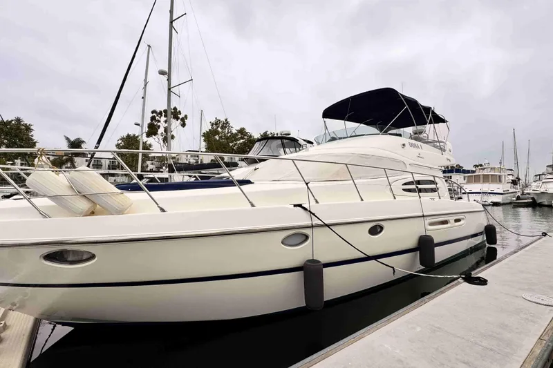 Slide: The Image of Luxury Cranchi yacht docked at marina, featuring sleek design and modern amenities. - 1