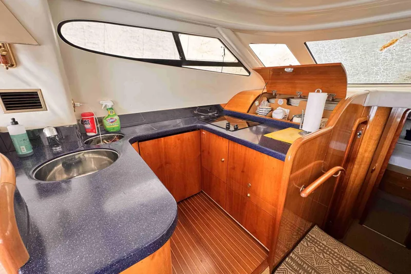 Slide: The Image of Luxurious Cranchi yacht kitchen with wooden cabinetry and modern amenities. - 11