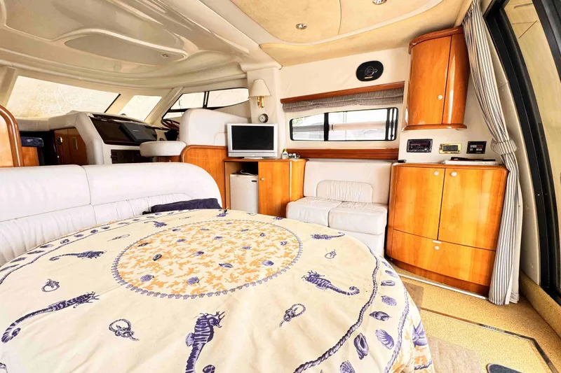 Slide: The Image of Luxurious Cranchi yacht interior with elegant wood cabinetry and cozy seating area. - 12