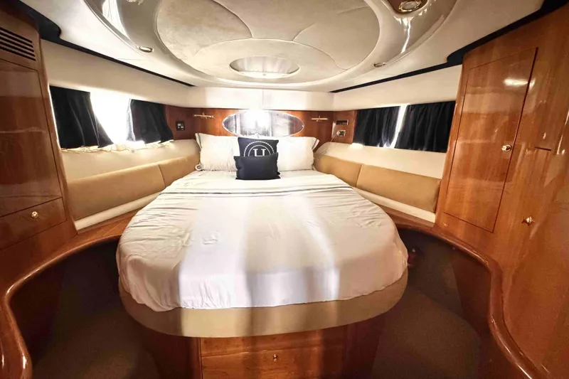 Slide: The Image of Luxurious Cranchi yacht cabin with elegant wood finish and cozy bedding. - 13