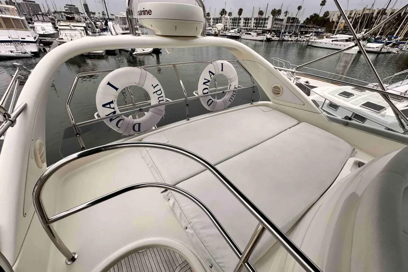 Slide: The Image of Luxurious Cranchi yacht deck with sunbathing area, docked in a marina. - 16