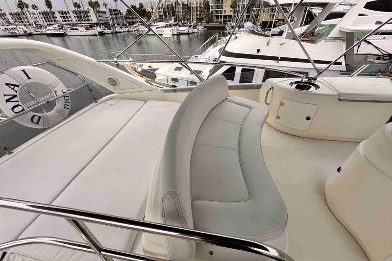 Slide: The Image of Luxurious Cranchi yacht deck with seating, docked at marina with other boats. - 18