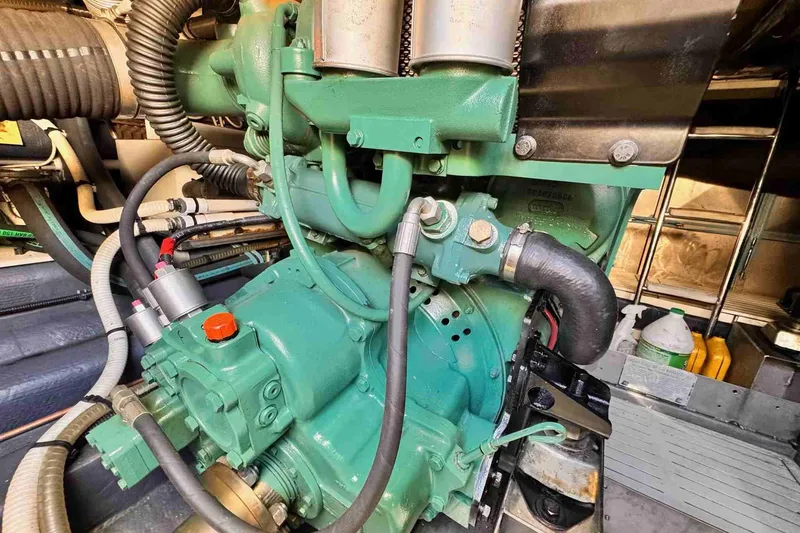 Slide: The Image of Engine compartment of 2003 Cranchi Atlantique 50 yacht, showcasing mechanical components and hoses. - 21