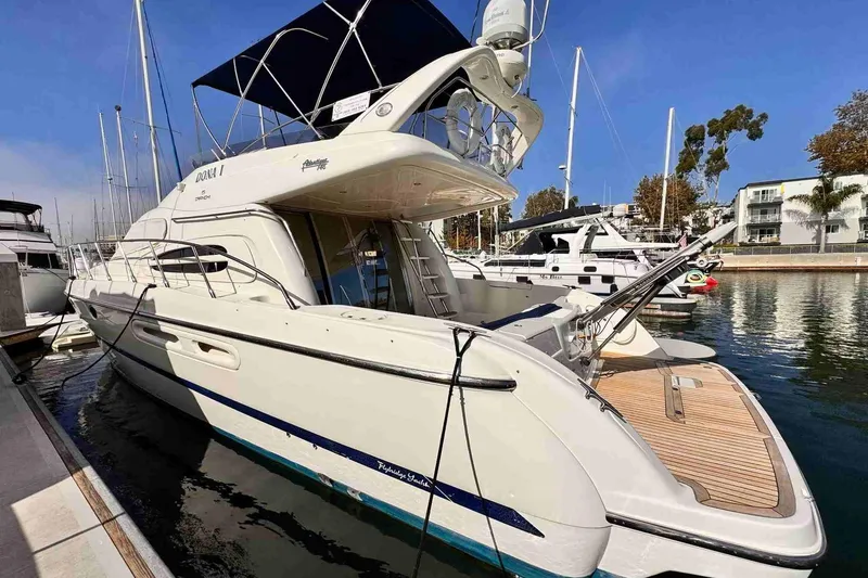 Slide: The Image of 2003 Cranchi Atlantique 50 yacht docked at marina, featuring sleek design and spacious deck. - 3