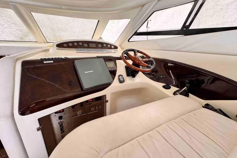 Slide: The Image of Cranchi boat cockpit with wooden steering wheel and navigation equipment. - 9