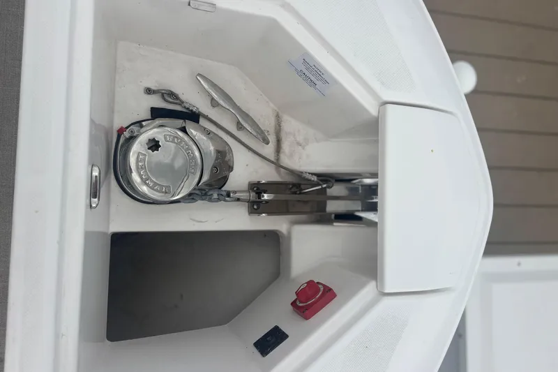 Slide: The Image of Anchor compartment of 2024 Regal 36 XO boat with winch and cleat. - 11