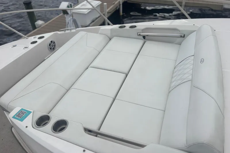 Slide: The Image of 2024 Regal 36 XO boat with luxurious white seating and cup holders. - 12