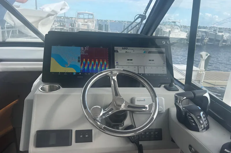 Slide: The Image of 2024 Regal 36 XO boat helm with Garmin navigation system and controls. - 17