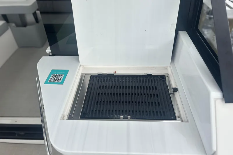 Slide: The Image of Outdoor grill on 2024 Regal 36 XO boat with QR code for information. - 25