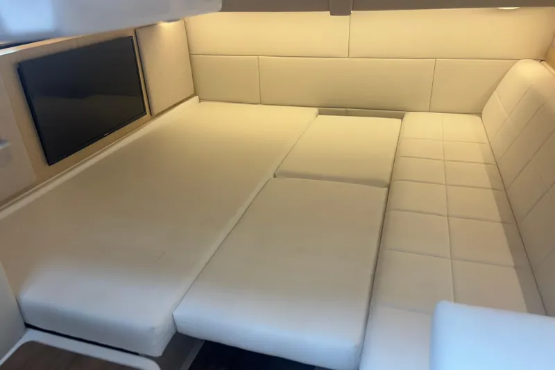 Slide: The Image of 2024 Regal 36 XO interior with plush white seating and wall-mounted TV. - 29