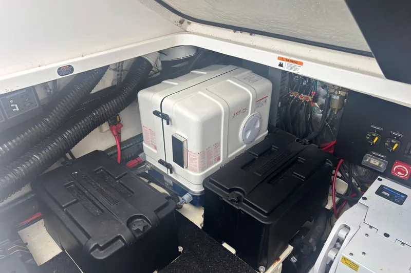 Slide: The Image of Engine compartment of 2024 Regal 36 XO boat, featuring batteries and wiring. - 31