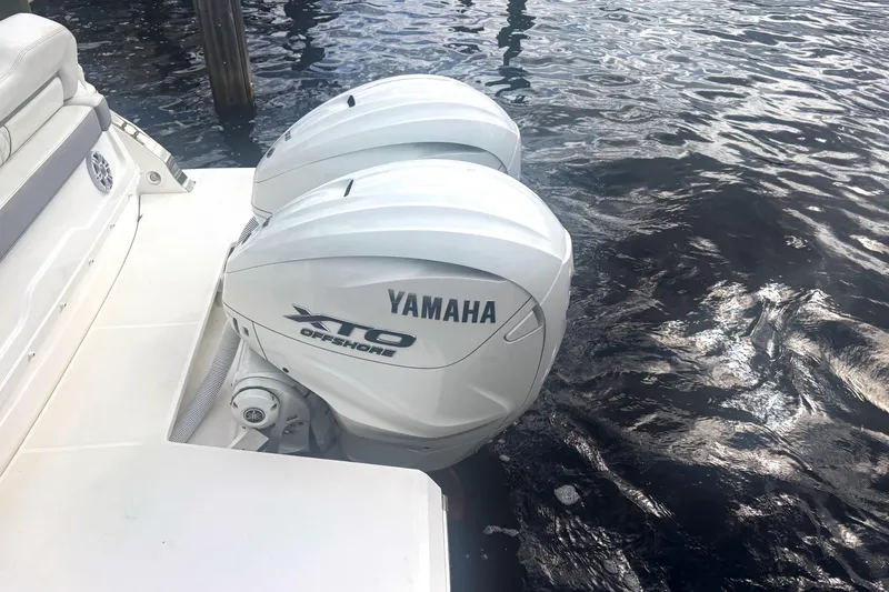 Slide: The Image of 2024 Regal 36 XO boat with Yamaha XTO Offshore engines on water. - 7
