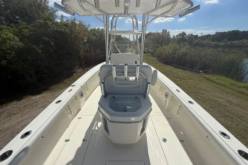 Slide: The Image of 2026 Pathfinder 2400 Open boat interior with seating and console, surrounded by lush greenery. - 13