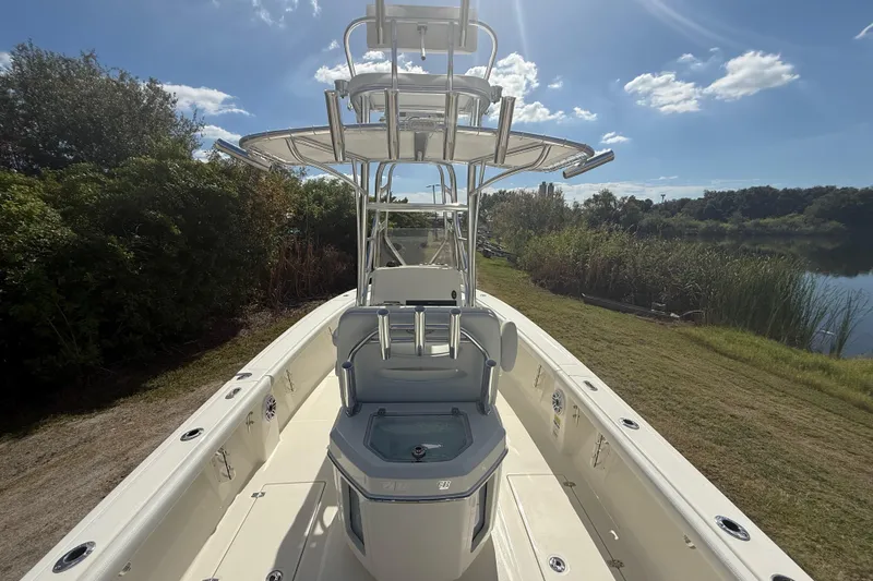 Slide: The Image of 2026 Pathfinder 2400 Open boat on grassy shore under clear blue sky. - 15