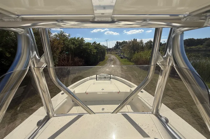 Slide: The Image of 2026 Pathfinder 2400 Open boat on a dirt path, surrounded by greenery. - 18