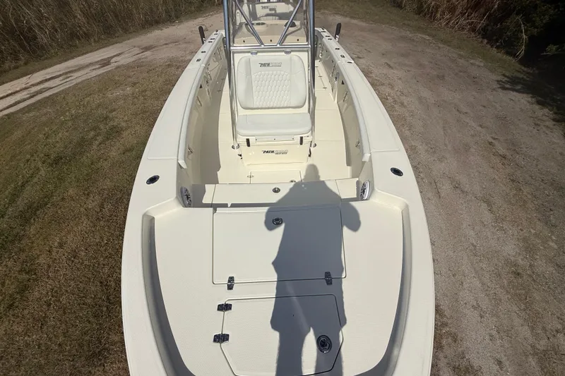 Slide: The Image of 2026 Pathfinder 2400 Open boat on grassy terrain, showcasing spacious deck and seating. - 20