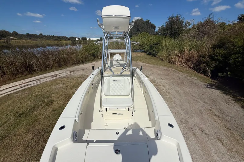 Slide: The Image of 2026 Pathfinder 2400 Open boat on grassy shore, clear sky background. - 21