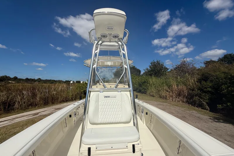 Slide: The Image of 2026 Pathfinder 2400 Open boat with T-top, white seating, and clear blue sky background. - 22