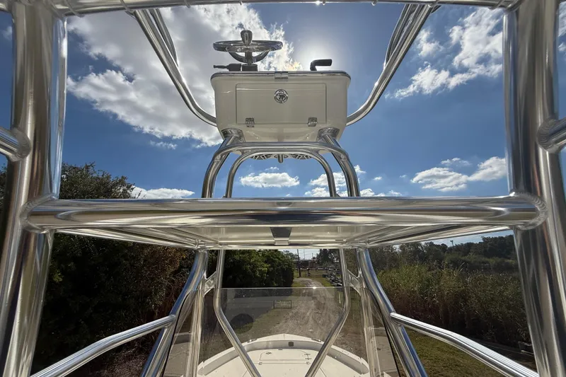 Slide: The Image of 2026 Pathfinder 2400 Open boat with sleek metal framework under a bright blue sky. - 24