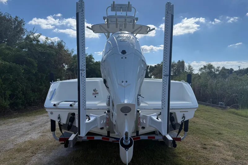 Slide: The Image of 2026 Pathfinder 2400 Open boat rear view, parked on grass under blue sky. - 3