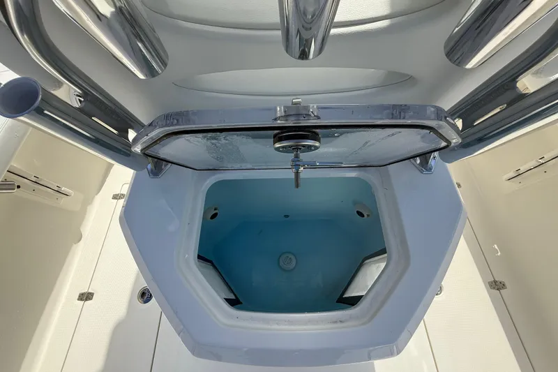Slide: The Image of Livewell compartment on 2026 Pathfinder 2400 Open boat, featuring stainless steel fittings. - 32