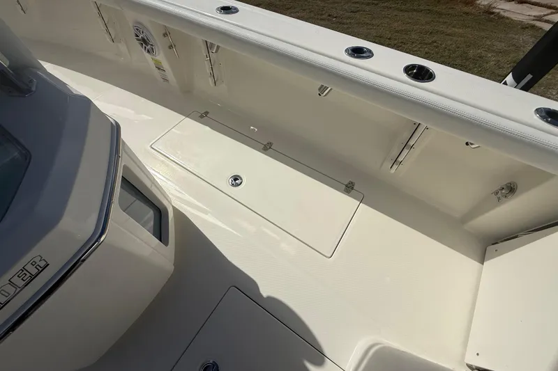 Slide: The Image of 2026 Pathfinder 2400 Open boat interior with storage compartment and rod holders. - 33