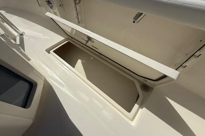 Slide: The Image of 2026 Pathfinder 2400 Open boat storage compartment with open lid, showcasing interior space. - 34