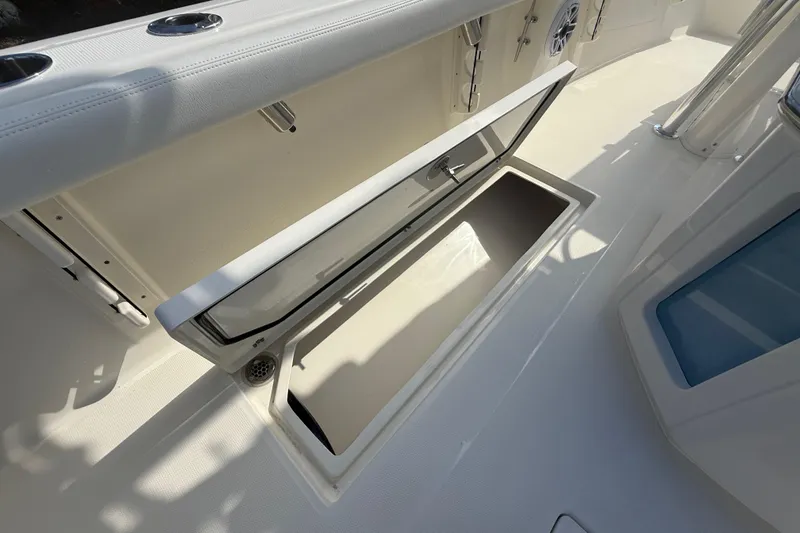 Slide: The Image of 2026 Pathfinder 2400 Open boat storage compartment with open hatch, showcasing interior space. - 36