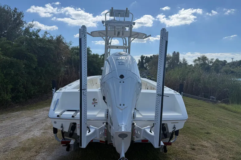 Slide: The Image of 2026 Pathfinder 2400 Open boat, rear view, parked on grass under blue sky. - 4