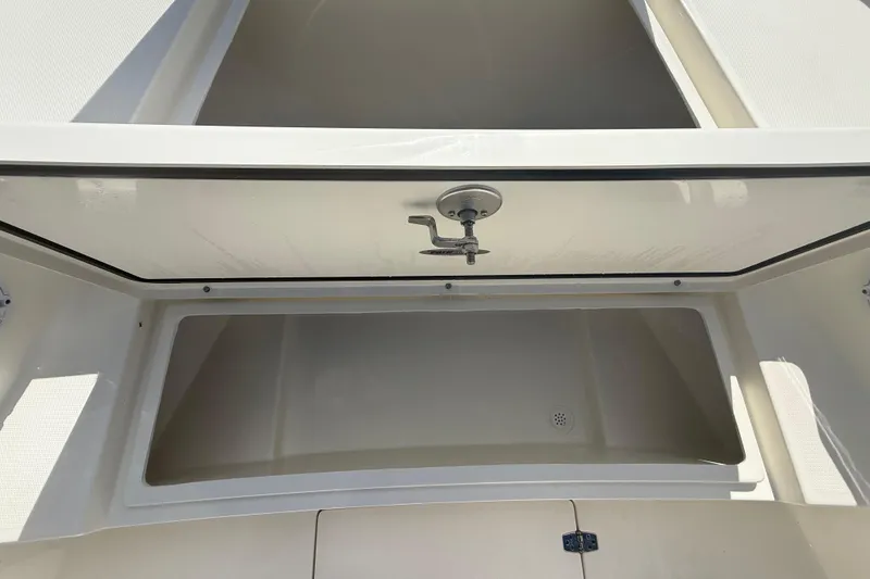 Slide: The Image of 2026 Pathfinder 2400 Open boat storage compartment with open hatch and latch. - 47
