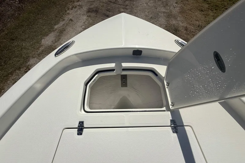 Slide: The Image of 2026 Pathfinder 2400 Open boat storage compartment with open hatch, showcasing interior space. - 49