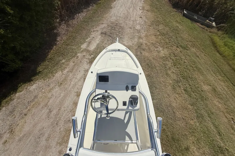 Slide: The Image of 2026 Pathfinder 2400 Open boat on grassy path, aerial view. - 51