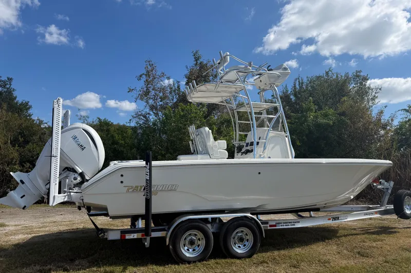 Slide: The Image of 2026 Pathfinder 2400 Open boat on trailer, parked outdoors under a blue sky. - 7