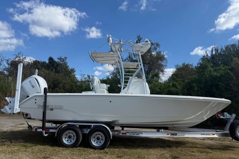 Slide: The Image of 2026 Pathfinder 2400 Open boat on trailer, parked outdoors under blue sky. - 8