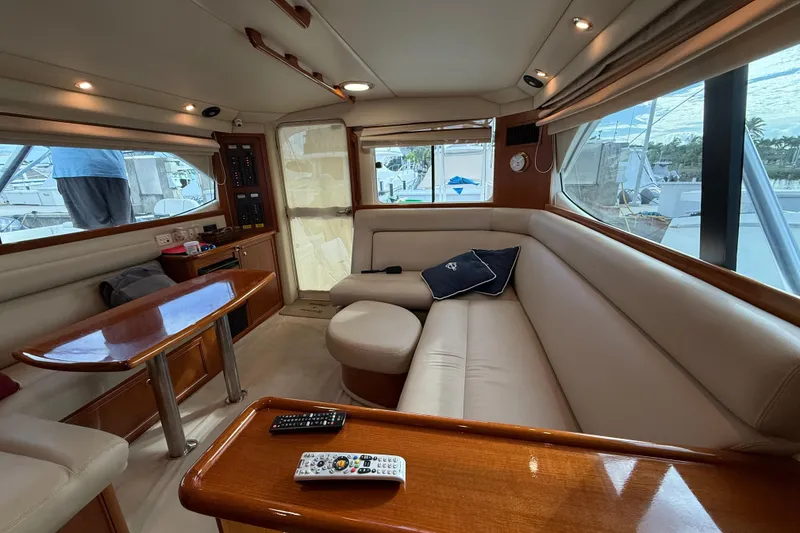 Slide: The Image of Luxurious interior of 2005 Riviera 40 Flybridge yacht with plush seating and wooden accents. - 14
