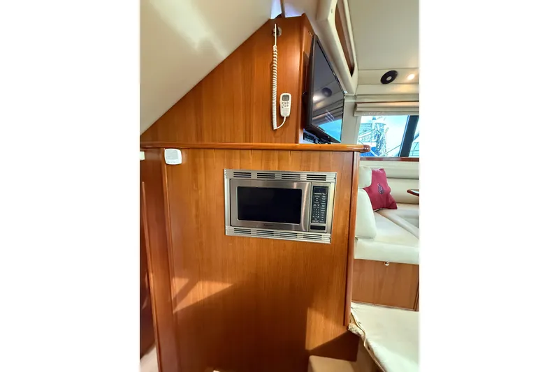 Slide: The Image of Interior of 2005 Riviera 40 Flybridge yacht with built-in microwave and seating area. - 15