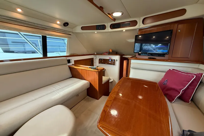 Slide: The Image of Luxurious interior of 2005 Riviera 40 Flybridge yacht with plush seating and TV. - 16