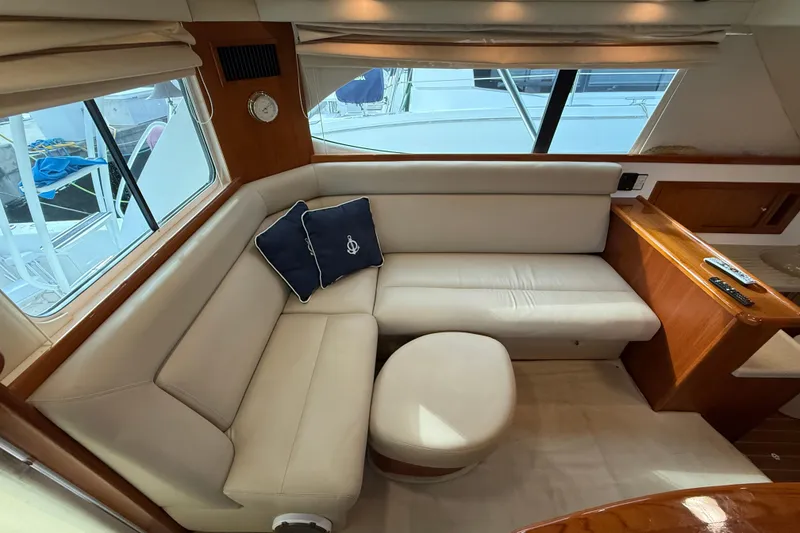 Slide: The Image of Luxurious interior of 2005 Riviera 40 Flybridge yacht with cream leather seating and nautical decor. - 17