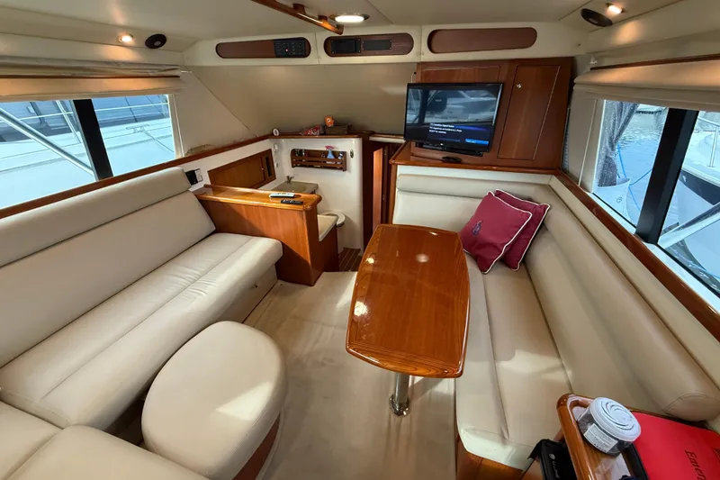 Slide: The Image of Luxurious interior of 2005 Riviera 40 Flybridge yacht with elegant seating and wooden table. - 18