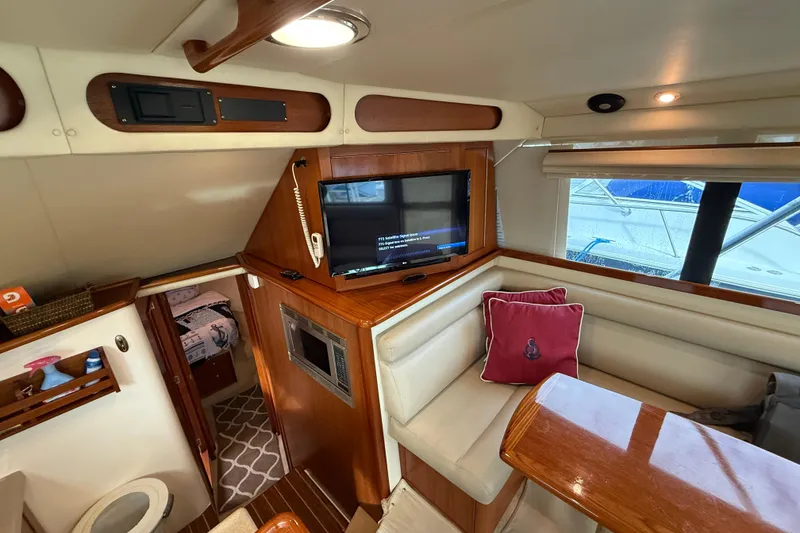 Slide: The Image of Interior of 2005 Riviera 40 Flybridge yacht with cozy seating and modern amenities. - 19