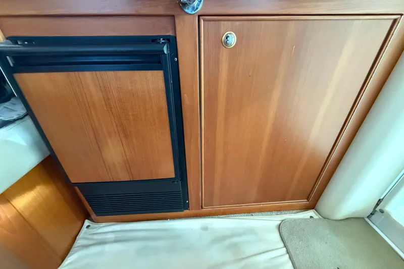 Slide: The Image of Interior view of 2005 Riviera 40 Flybridge with wooden cabinetry and compact fridge. - 21
