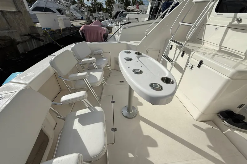 Slide: The Image of 2005 Riviera 40 Flybridge yacht deck with seating and table setup. - 24