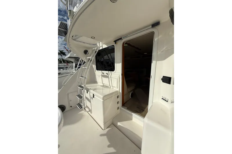 Slide: The Image of 2005 Riviera 40 Flybridge yacht with ladder and open cabin door. - 25