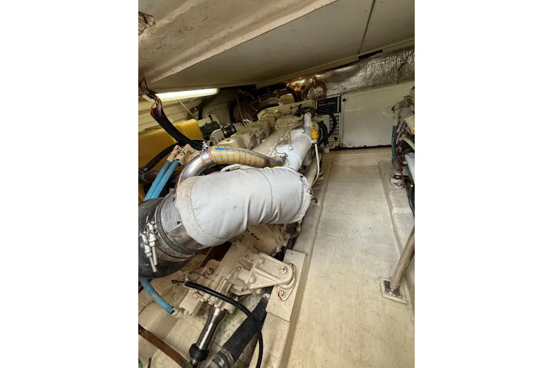 Slide: The Image of Engine room of a 2005 Riviera 40 Flybridge yacht, showcasing mechanical components. - 26