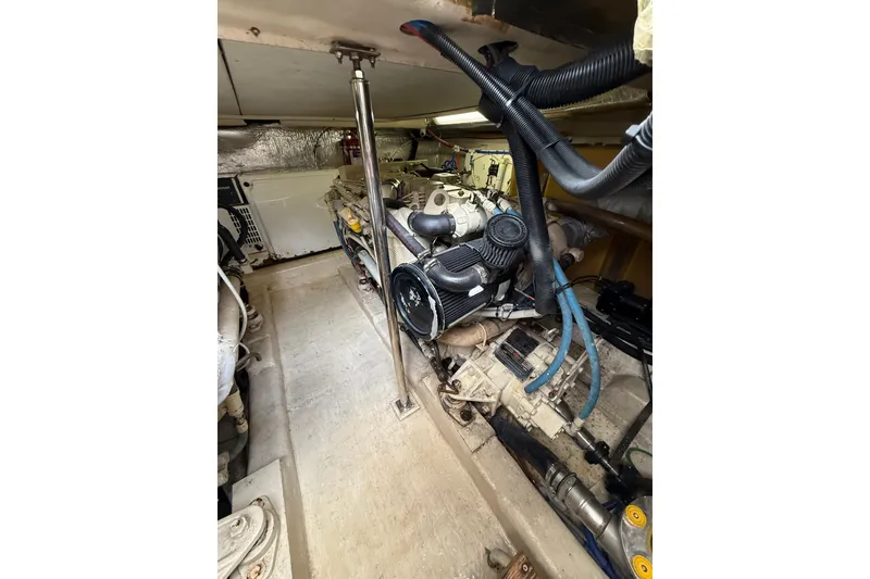 Slide: The Image of Engine room of 2005 Riviera 40 Flybridge yacht, showcasing mechanical components and wiring. - 27